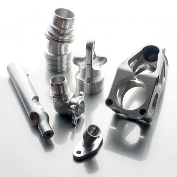 Machined metal parts photographed on shiny surface